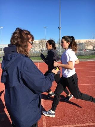 Coach James timing juniors Hannah Salinas and Hannah James