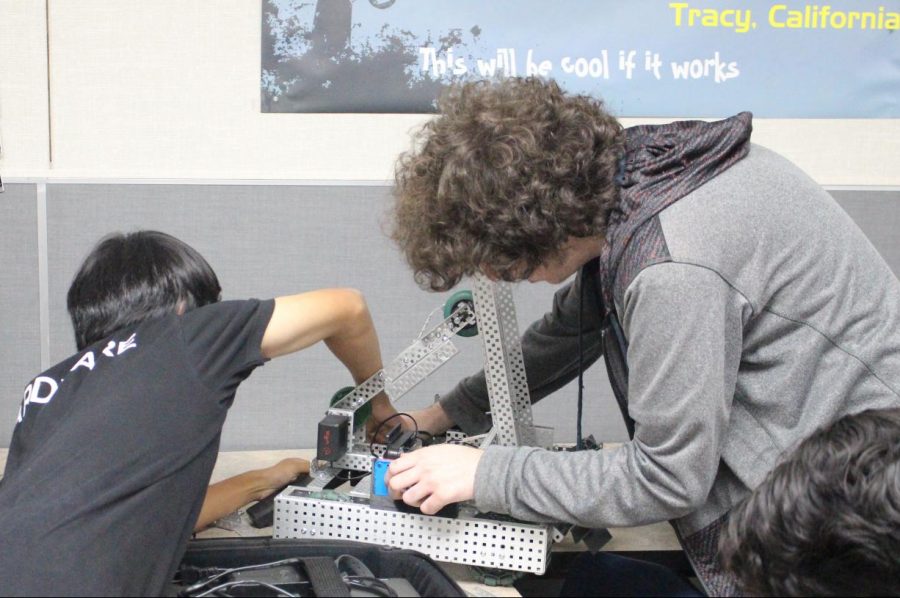 Junior Matthew Leung and senior Jayce Thorburn work on a robot for an upcoming tournament. Photo by Veron Hollins.
