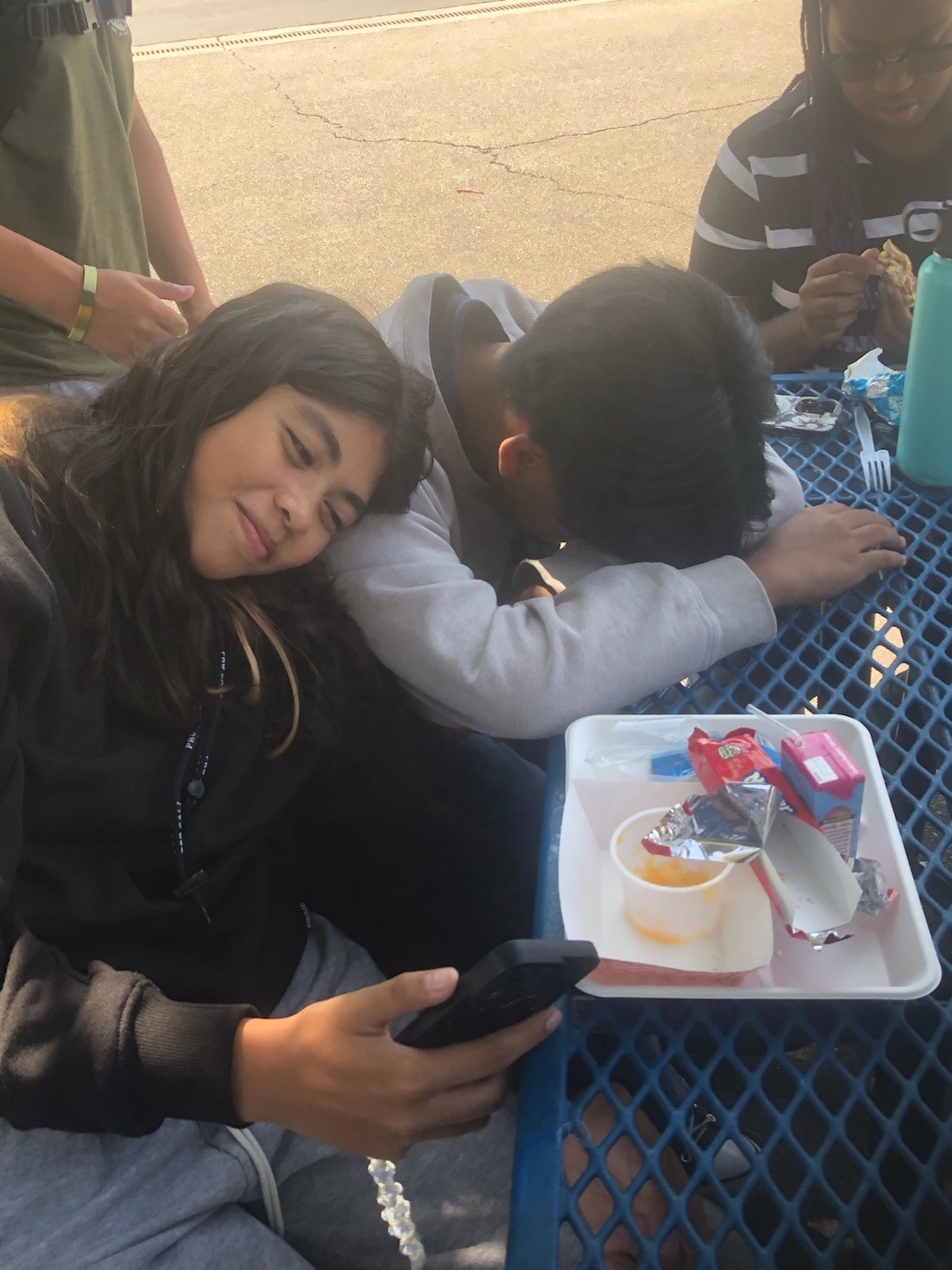 Students Janessa Hallman (left) and Liam Acelar (Right) relax during lunch by talking and going on social media