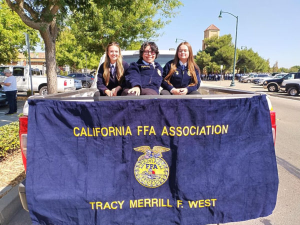 FFA officers President Peyton DeCoite, Historian Trinity Fulton, and Event Committee Chair Angelina Cruz participate in the 2023 Homecoming parade in downtown Tracy.