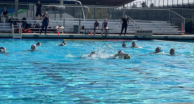 WaterPolo+team+competing+in+a+match.