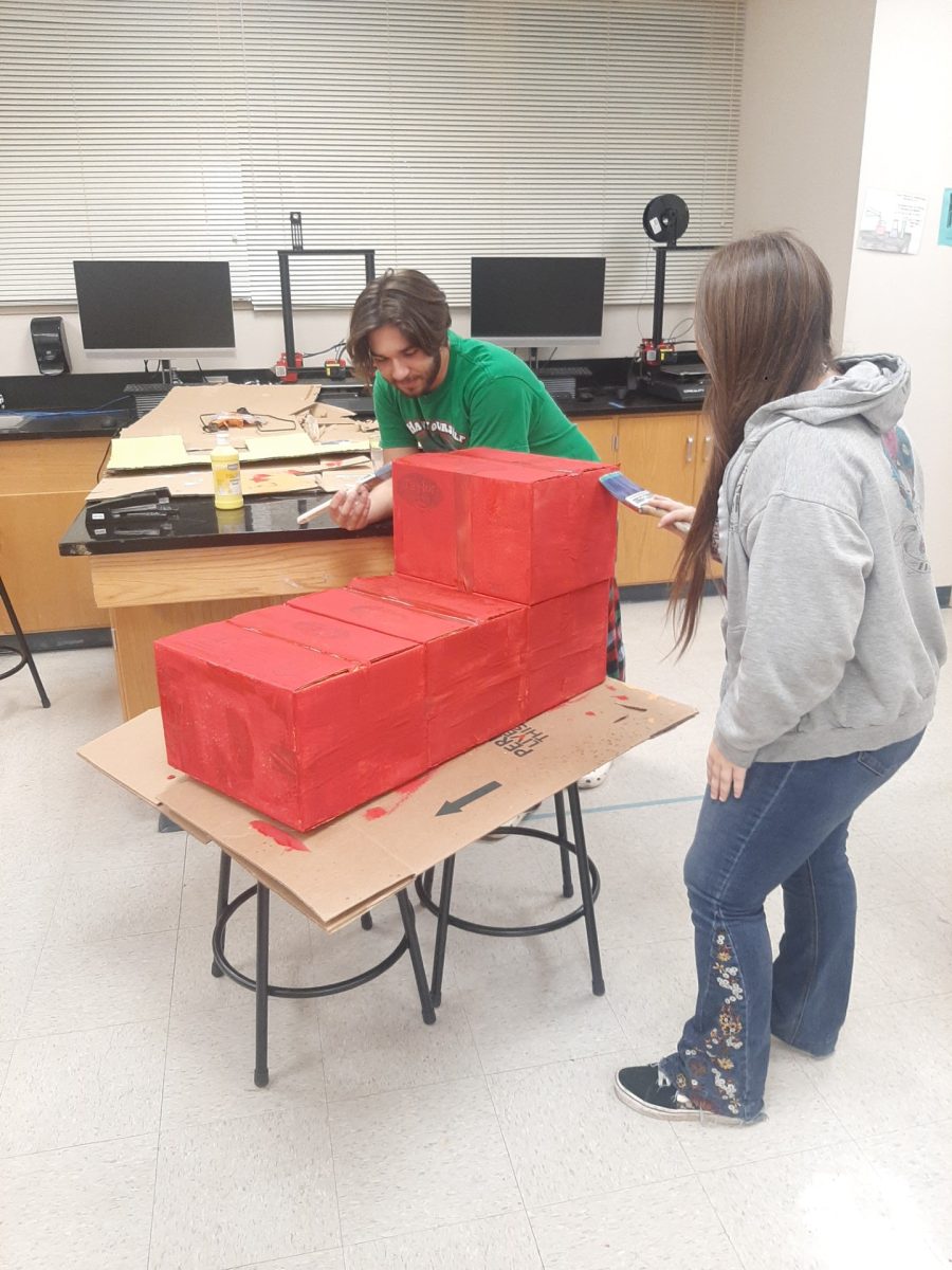 Caleb Cosme (Left) and another leadership student (right) working on Packfest props