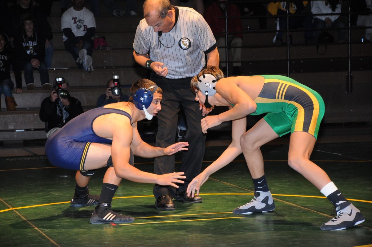 Rogelio Bravo (Blue singlet) in a wrestling match during his time at West