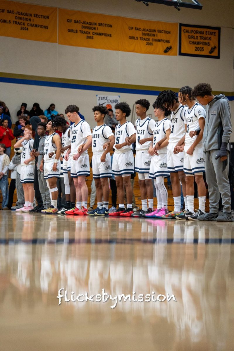 2024-25 Boys Varsity Basketball team lining up before their game