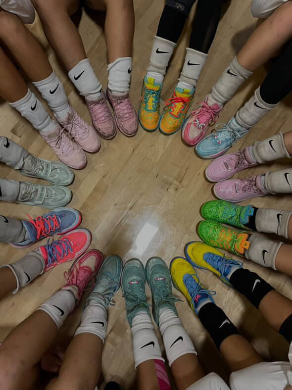 The Varsity Girl's Volleyball Team Showing off their shoes