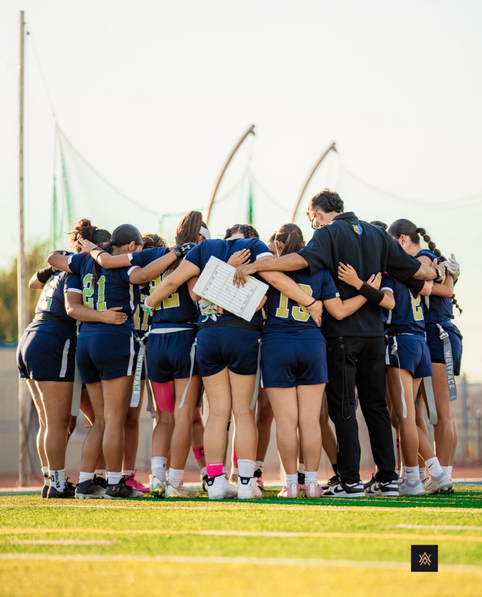 The Flag Football Team and Coach A huddled together