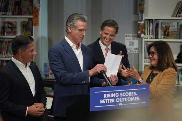 Gov. Gavin Newsom signs legislation related to student literacy, surrounded from left, Alberto Carvalho, Superintendent of Los Angeles Unified School District, Marshall Tuck, EdVoice CEO, and Martha Hernandez, Executive Director, Californians Together in Los Angeles on Thursday, Oct. 9, 2025. (AP Photo/Damian Dovarganes)